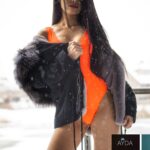 Attractive Thai massage girl in orange bathing suit